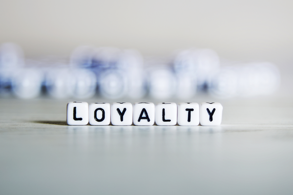 Dice with letters on them spelling word 'LOYALTY'